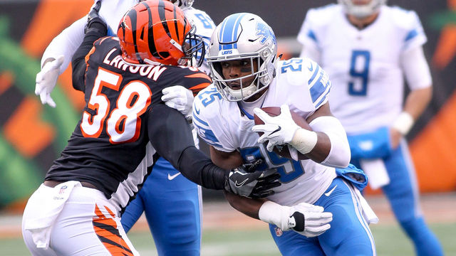 CINCINNATI, OH - DECEMBER 24: Theo Riddick #25 of the Detroit Lions runs with the ball past Carl Lawson #58 of the Cincinnati Bengals during the first half at Paul Brown Stadium on December 24, 2017 in Cincinnati, Ohio.