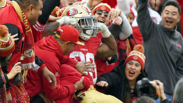SANTA CLARA, CA - DECEMBER 24: Carlos Hyde #28 of the San Francisco 49ers celebrates in the stands with fans after he scored a touchdown against the Jacksonville Jaguars during their NFL football game at Levi's Stadium on December 24, 2017 in Santa Clara, California.