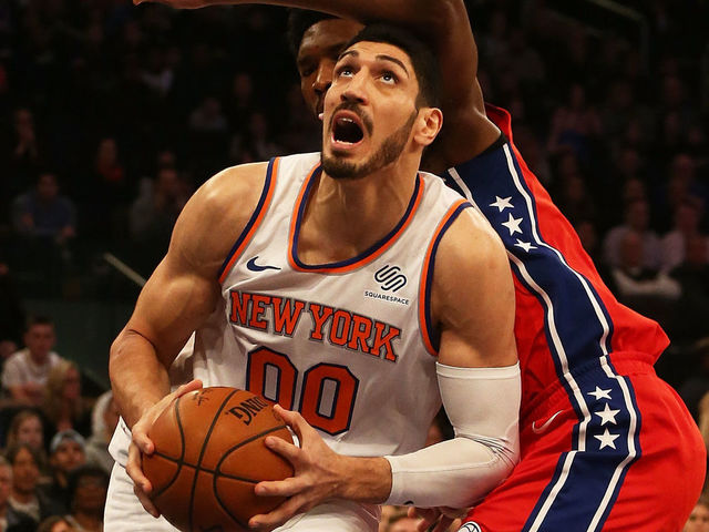 NEW YORK, NY - DECEMBER 25: Enes Kanter #00 of the New York Knicks drives to th ebasket against Joel Embiid #21 of the Philadelphia 76ers at Madison Square Garden on December 25, 2017 in New York City.