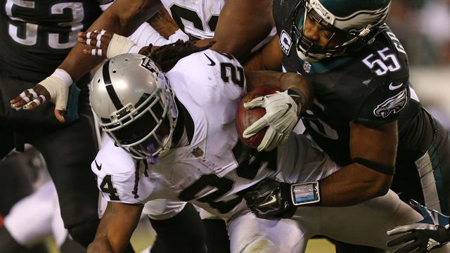 PHILADELPHIA, PA - DECEMBER 25: Marshawn Lynch #24 of the Oakland Raiders is tackled by Brandon Graham #55 of the Philadelphia Eagles during the second quarter of a game at Lincoln Financial Field on December 25, 2017 in Philadelphia, Pennsylvania.