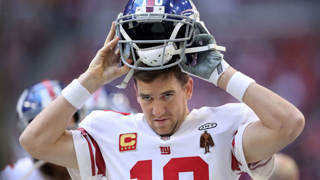 GLENDALE, AZ - DECEMBER 24: Quarterback Eli Manning #10 of the New York Giants puts on his helmet in the first half against the Arizona Cardinals at University of Phoenix Stadium on December 24, 2017 in Glendale, Arizona.