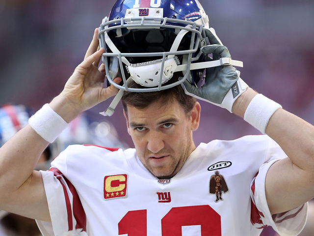 GLENDALE, AZ - DECEMBER 24: Quarterback Eli Manning #10 of the New York Giants puts on his helmet in the first half against the Arizona Cardinals at University of Phoenix Stadium on December 24, 2017 in Glendale, Arizona.