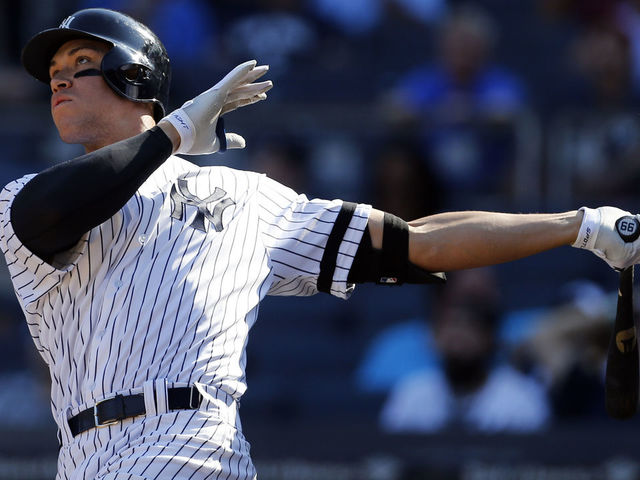 NEW YORK, NY - SEPTEMBER 25: Aaron Judge #99 of the New York Yankees hits a solo home run against the Kansas City Royals during the seventh inning at Yankee Stadium on September 25, 2017 in the Bronx borough of New York City. The home run was number 50 on the season.