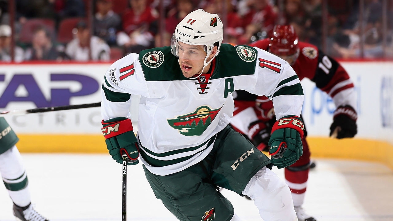 GLENDALE, AZ - APRIL 08: Zach Parise #11 of the Minnesota Wild skates with the puck ahead of Marco Scandella #6 and Anthony Duclair #10 of the Arizona Coyotes during the third period of the NHL game at Gila River Arena on April 8, 2017 in Glendale, Arizona. The Wild defeated the Coyotes 3-1.