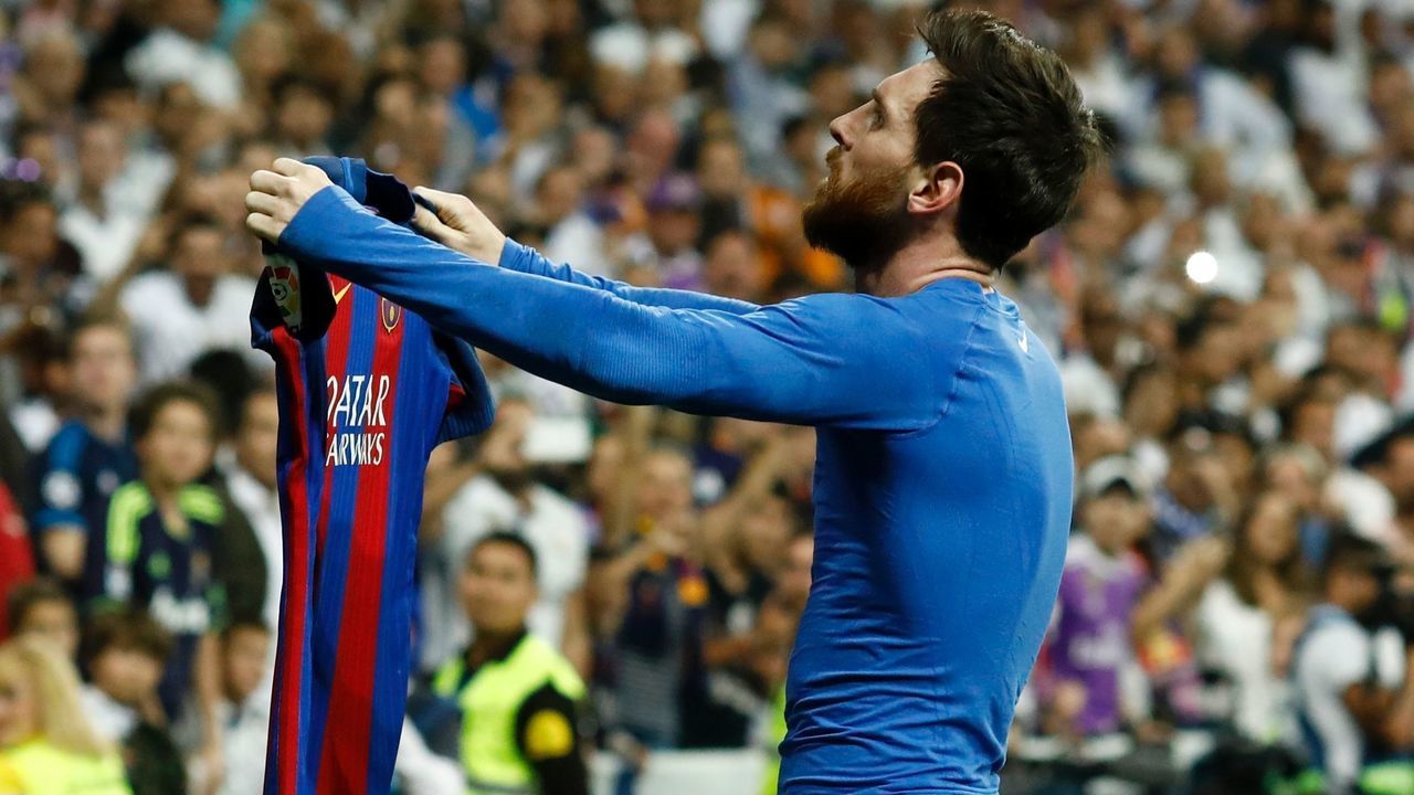 Barcelona's Argentinian forward Lionel Messi celebrates after scoring during the Spanish league Clasico football match Real Madrid CF vs FC Barcelona at the Santiago Bernabeu stadium in Madrid on April 23, 2017. / AFP PHOTO / OSCAR DEL POZO