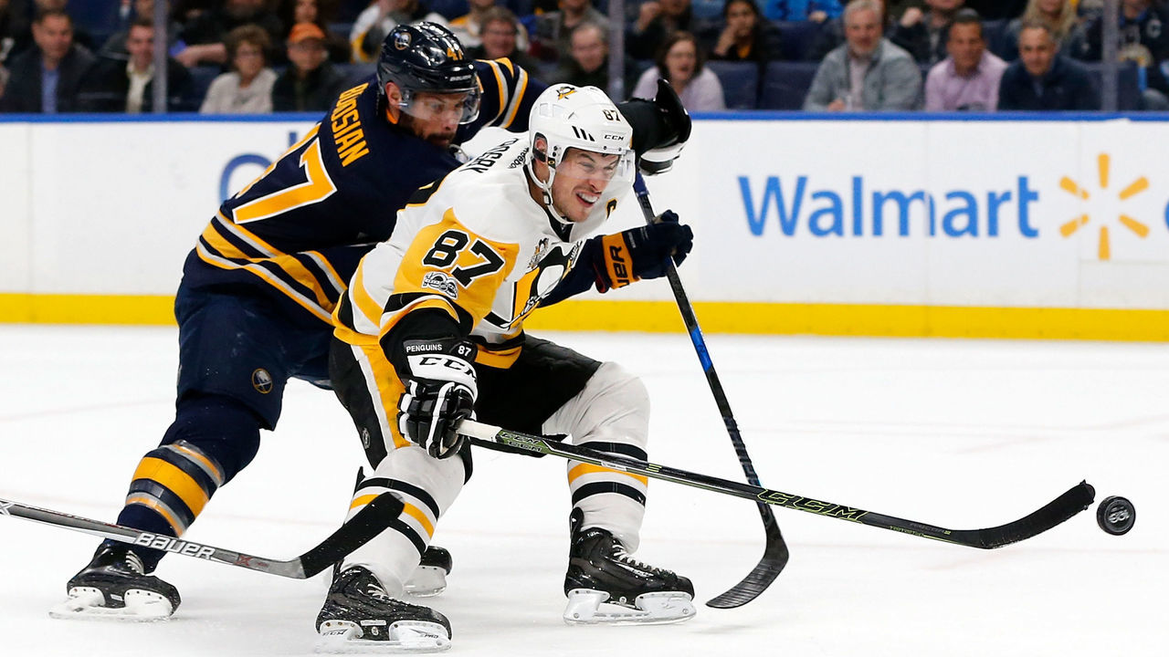 BUFFALO, NY - MARCH 21: Sidney Crosby #87 of the Pittsburgh Penguins scores with one hand on a breakaway as Zach Bogosian #47 of the Buffalo Sabres tries to defend during the first period at the KeyBank Center on March 21, 2017 in Buffalo, New York. *** Local Caption ***Sidney Crosby;Zach Bogosian