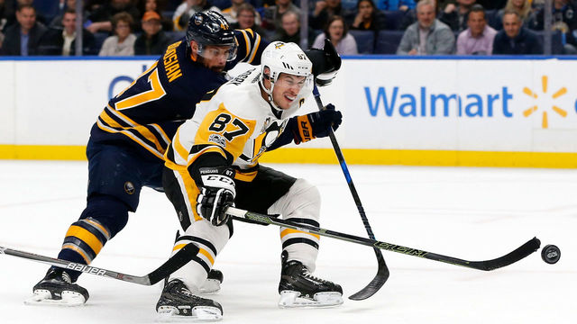 BUFFALO, NY - MARCH 21: Sidney Crosby #87 of the Pittsburgh Penguins scores with one hand on a breakaway as Zach Bogosian #47 of the Buffalo Sabres tries to defend during the first period at the KeyBank Center on March 21, 2017 in Buffalo, New York. *** Local Caption ***Sidney Crosby;Zach Bogosian