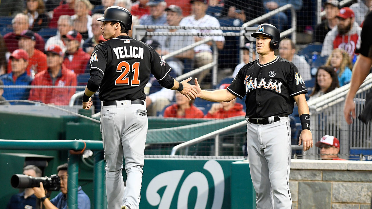 WASHINGTON, DC - APRIL 05: Christian Yelich #21 and J.T. Realmuto #11 of the Miami Marlins celebrate after scoring in the first inning against the Washington Nationals at Nationals Park on April 5, 2017 in Washington, DC.