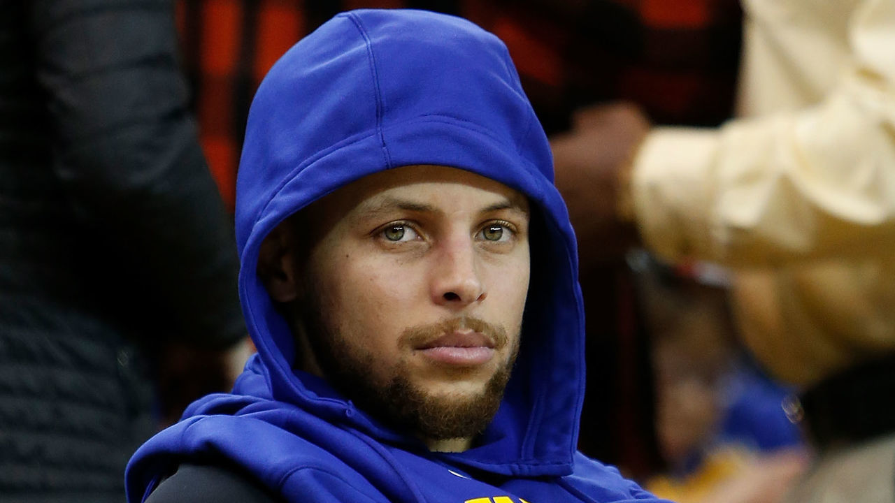 OAKLAND, CA - DECEMBER 23: Stephen Curry #30 of the Golden State Warriors looks on from the bench during warm ups before the game against the Denver Nuggets at ORACLE Arena on December 23, 2017 in Oakland, California.