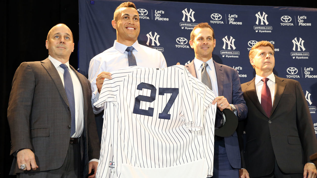 ORLANDO, FL - DECEMBER 11: General Manager Brian Cashman, Giancarlo Stanton, Manager Aaron Boone and owner Hal Steinbrenner of the New York Yankees pose for a photo after Stanton is introduced as a Yankees during a press conference at the 2017 Winter Meetings at the Walt Disney World Swan and Dolphin Resort on Monday, December 11, 2017 in Orlando, Florida.