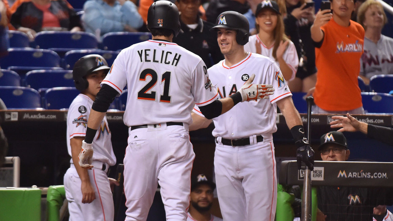 MIAMI, FL - SEPTEMBER 19: Christian Yelich #21 of the Miami Marlins is congratulated by J.T. Realmuto #11 after hitting a home run in the fourth inning against the New York Mets at Marlins Park on September 19, 2017 in Miami, Florida.