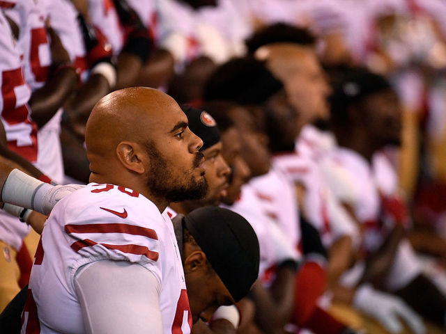 INDIANAPOLIS, IN - OCTOBER 08: Xavier Cooper #96 of the San Francisco 49ers and other members of the team kneel during the National Anthem before the game against the Indianapolis Colts at Lucas Oil Stadium on October 8, 2017 in Indianapolis, Indiana.