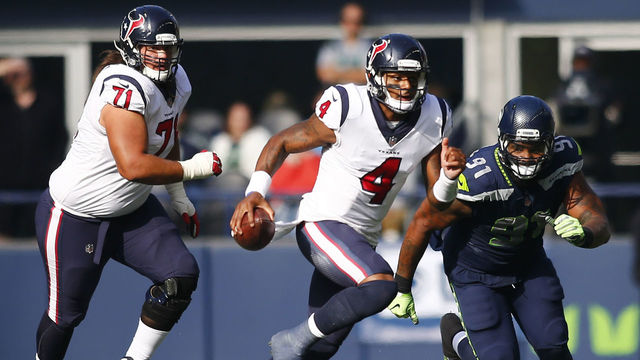 SEATTLE, WA - OCTOBER 29: Quarterback Deshaun Watson #4 of the Houston Texans escapes defensive tackle Sheldon Richardson #91 of the Seattle Seahawks during the first half at CenturyLink Field on October 29, 2017 in Seattle, Washington.