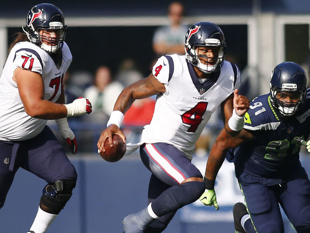 SEATTLE, WA - OCTOBER 29: Quarterback Deshaun Watson #4 of the Houston Texans escapes defensive tackle Sheldon Richardson #91 of the Seattle Seahawks during the first half at CenturyLink Field on October 29, 2017 in Seattle, Washington.