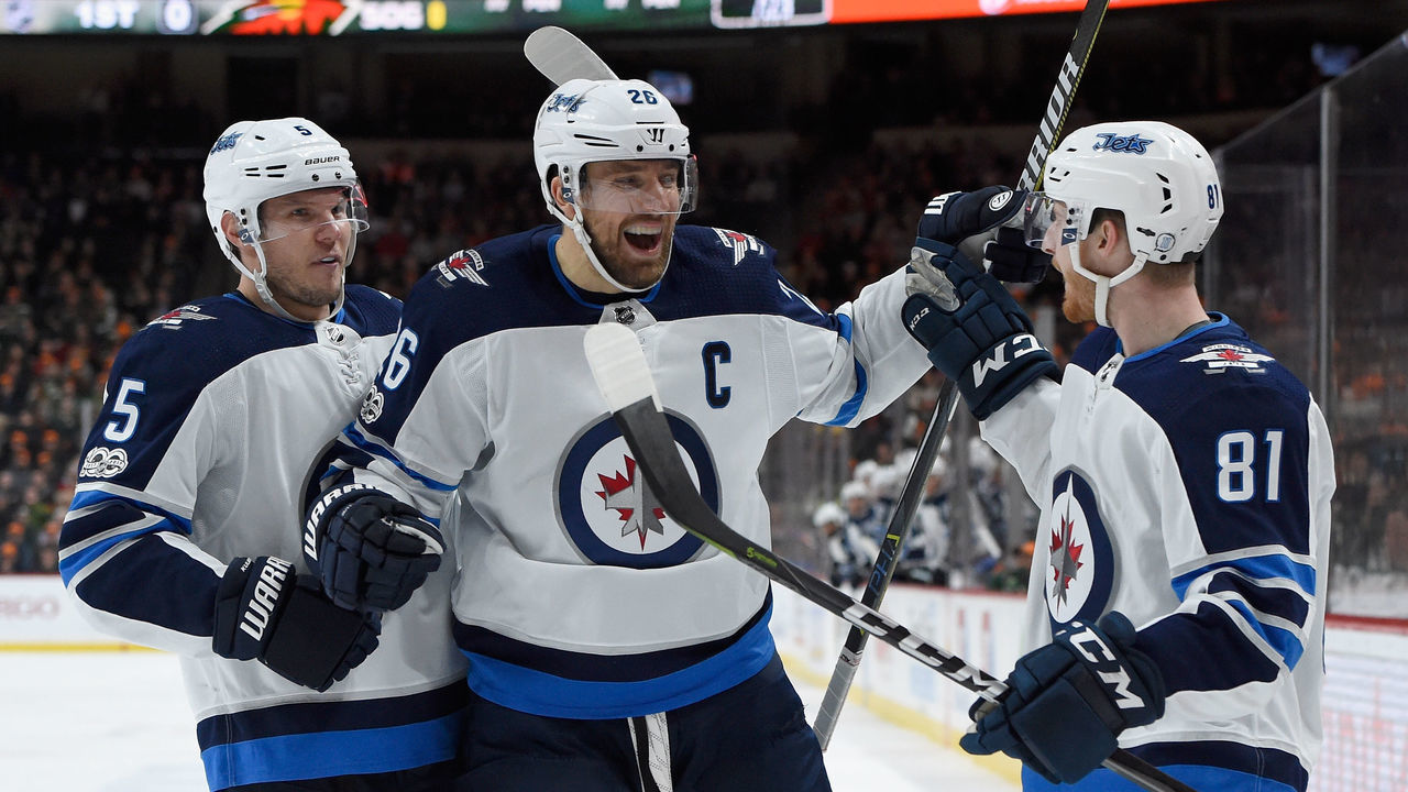 ST PAUL, MN - OCTOBER 31: Dmitry Kulikov #5 and Blake Wheeler #26 of the Winnipeg Jets congratulate teammate Kyle Connor #81 on scoring a goal against the Minnesota Wild during the first period of the game on October 31, 2017 at Xcel Energy Center in St Paul, Minnesota.