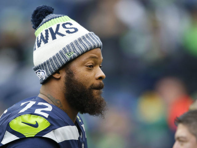 SEATTLE, WA - DECEMBER 17: Defensive end Michael Bennett #72 of the Seattle Seahawks walks the field before the game against the Los Angeles Rams at CenturyLink Field on December 17, 2017 in Seattle, Washington.