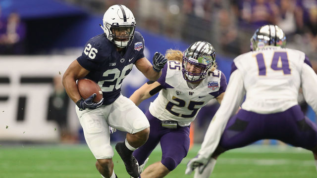 GLENDALE, AZ - DECEMBER 30: Running back Saquon Barkley #26 of the Penn State Nittany Lions rushes the football past linebacker Ben Burr-Kirven #25 of the Washington Huskies during the first half of the Playstation Fiesta Bowl at University of Phoenix Stadium on December 30, 2017 in Glendale, Arizona.