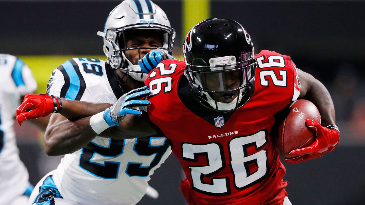 ATLANTA, GA - DECEMBER 31: Tevin Coleman #26 of the Atlanta Falcons is tackled by Mike Adams #29 of the Carolina Panthers on a run during the first half Mercedes-Benz Stadium on December 31, 2017 in Atlanta, Georgia.