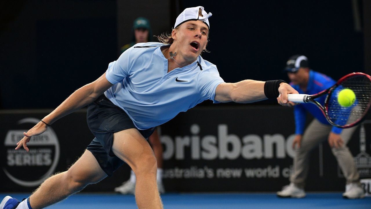 Denis Shapovalov of Canada reaches out for a return against Kyle Edmund of Britain during their second round match at the Brisbane International tennis tournament at the Pat Rafter Arena in Brisbane on January 2, 2018. / AFP PHOTO / SAEED KHAN / --IMAGE RESTRICTED TO EDITORIAL USE - STRICTLY NO COMMERCIAL USE--