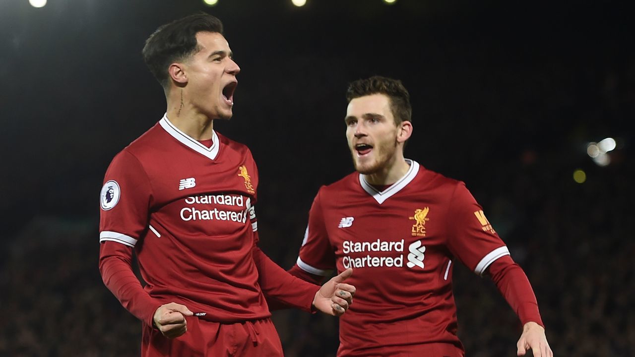 Liverpool's Brazilian midfielder Philippe Coutinho (L) celebrates scoring the English Premier League football match between Liverpool and Swansea City at Anfield in Liverpool, north west England on December 26, 2017. / AFP PHOTO / PAUL ELLIS /