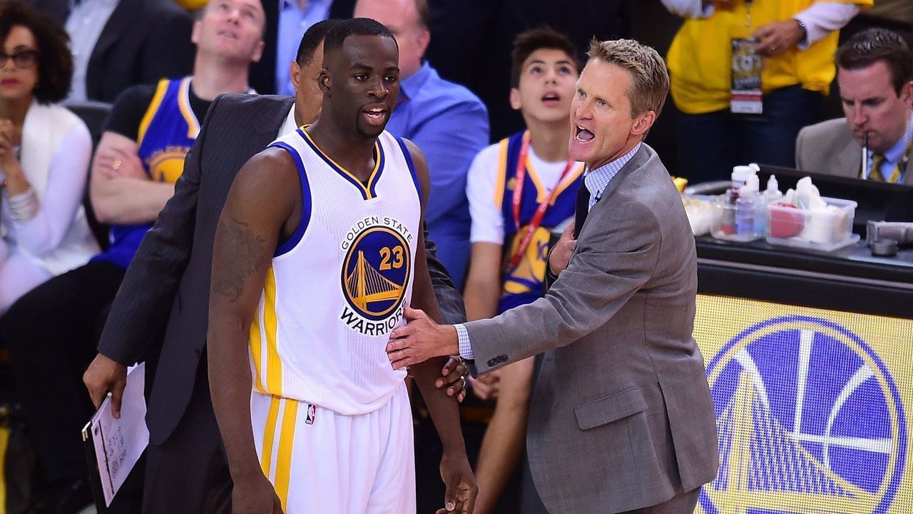 Golden State Warriors coach Steve Kerr gestures to keep Draymond Green from confronting the referee following a call against the Cleveland Cavaliers during Game 5 of the 2015 NBA Finals on June 14, 2015 at the Oracle Arena in Oakland, California. The Warriors defeated the Cavaliers 104-91 to lead the best of seven series 3-2. AFP PHOTO / FREDERIC J. BROWN