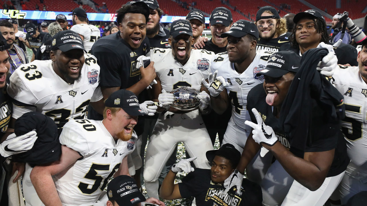 ATLANTA, GA - JANUARY 01: The UCF Knights celebrate defeating the Auburn Tigers 34-27 to win the Chick-fil-A Peach Bowl at Mercedes-Benz Stadium on January 1, 2018 in Atlanta, Georgia.