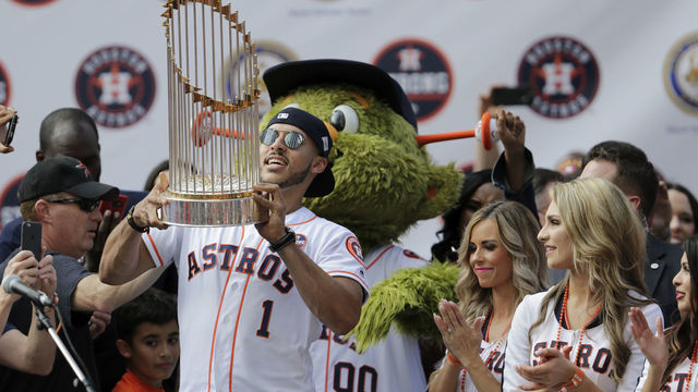 HOUSTON, TX - NOVEMBER 03: Carlos Correa #1 of the Houston Astros holds the World Series Trophy during the Houston Astros Victory Parade on November 3, 2017 in Houston, Texas. The Astros defeated the Los Angeles Dodgers 5-1 in Game 7 to win the 2017 World Series.