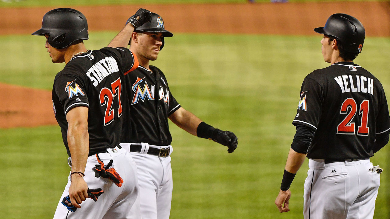 MIAMI, FL - JUNE 24: J.T. Realmuto #11 celebrates a 3 run homer with Giancarlo Stanton #27 and Christian Yelich #21 of the Miami Marlins during the game between the Miami Marlins and the Chicago Cubs at Marlins Park on June 24, 2017 in Miami, Florida.