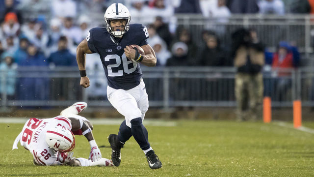 UNIVERSITY PARK, PA - NOVEMBER 18: Saquon Barkley #26 of the Penn State Nittany Lions slips by Kieron Williams #26 of the Nebraska Cornhuskers during a touchdown run during the first quarter on November 18, 2017 at Beaver Stadium in University Park, Pennsylvania.