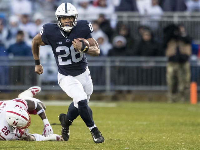 UNIVERSITY PARK, PA - NOVEMBER 18: Saquon Barkley #26 of the Penn State Nittany Lions slips by Kieron Williams #26 of the Nebraska Cornhuskers during a touchdown run during the first quarter on November 18, 2017 at Beaver Stadium in University Park, Pennsylvania.