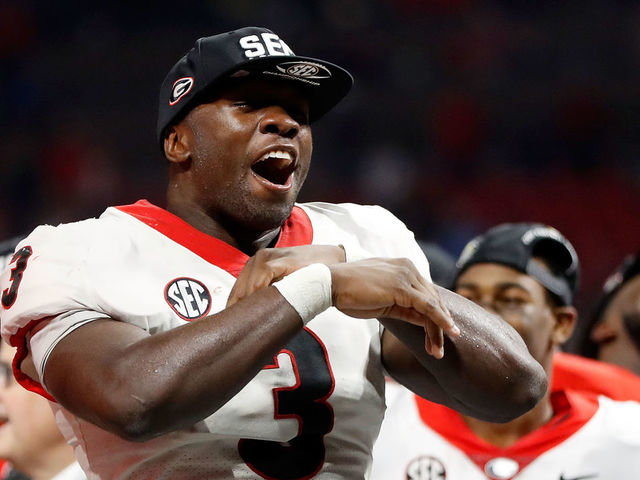 ATLANTA, GA - DECEMBER 02: Roquan Smith #3 of the Georgia Bulldogs reacts to winning the game MVP trophy after beating the Auburn Tigers in the SEC Championship at Mercedes-Benz Stadium on December 2, 2017 in Atlanta, Georgia.