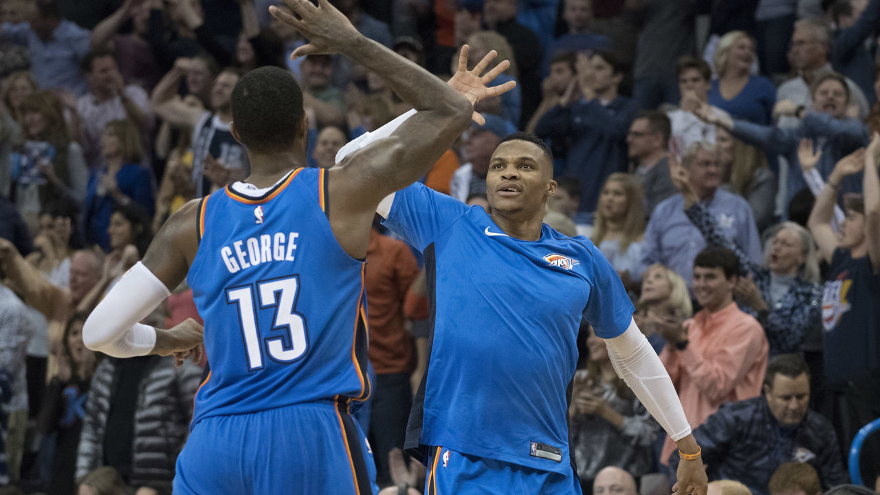 OKLAHOMA CITY, OK - NOVEMBER 22: Paul George #13 of the Oklahoma City Thunder and Russell Westbrook #0 of the Oklahoma City Thunder celebrate during the second half of a NBA game against the Golden State Warriors at the Chesapeake Energy Arena on November 22, 2017 in Oklahoma City, Oklahoma.