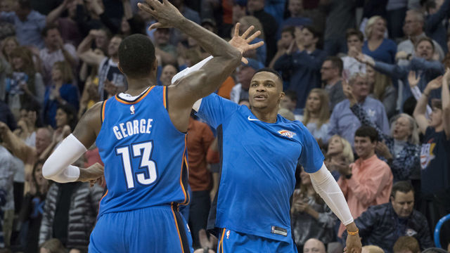 OKLAHOMA CITY, OK - NOVEMBER 22: Paul George #13 of the Oklahoma City Thunder and Russell Westbrook #0 of the Oklahoma City Thunder celebrate during the second half of a NBA game against the Golden State Warriors at the Chesapeake Energy Arena on November 22, 2017 in Oklahoma City, Oklahoma.