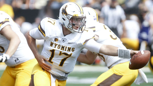 IOWA CITY, IOWA- SEPTEMBER 2: Quarterback Josh Allen #17 of the Wyoming Cowboys hands off the ball in the fourth quarter against the Iowa Hawkeyes, on September 2, 2017 at Kinnick Stadium in Iowa City, Iowa.