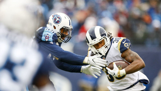 NASHVILLE, TN - DECEMBER 24: Running Back Todd Gurley II #30 of the Los Angeles Rams carries the ball against Linebacker Wesley Woodyard #59 of the Tennessee Titans at Nissan Stadium on December 24, 2017 in Nashville, Tennessee.