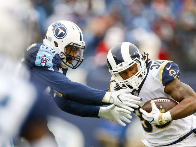 NASHVILLE, TN - DECEMBER 24: Running Back Todd Gurley II #30 of the Los Angeles Rams carries the ball against Linebacker Wesley Woodyard #59 of the Tennessee Titans at Nissan Stadium on December 24, 2017 in Nashville, Tennessee.
