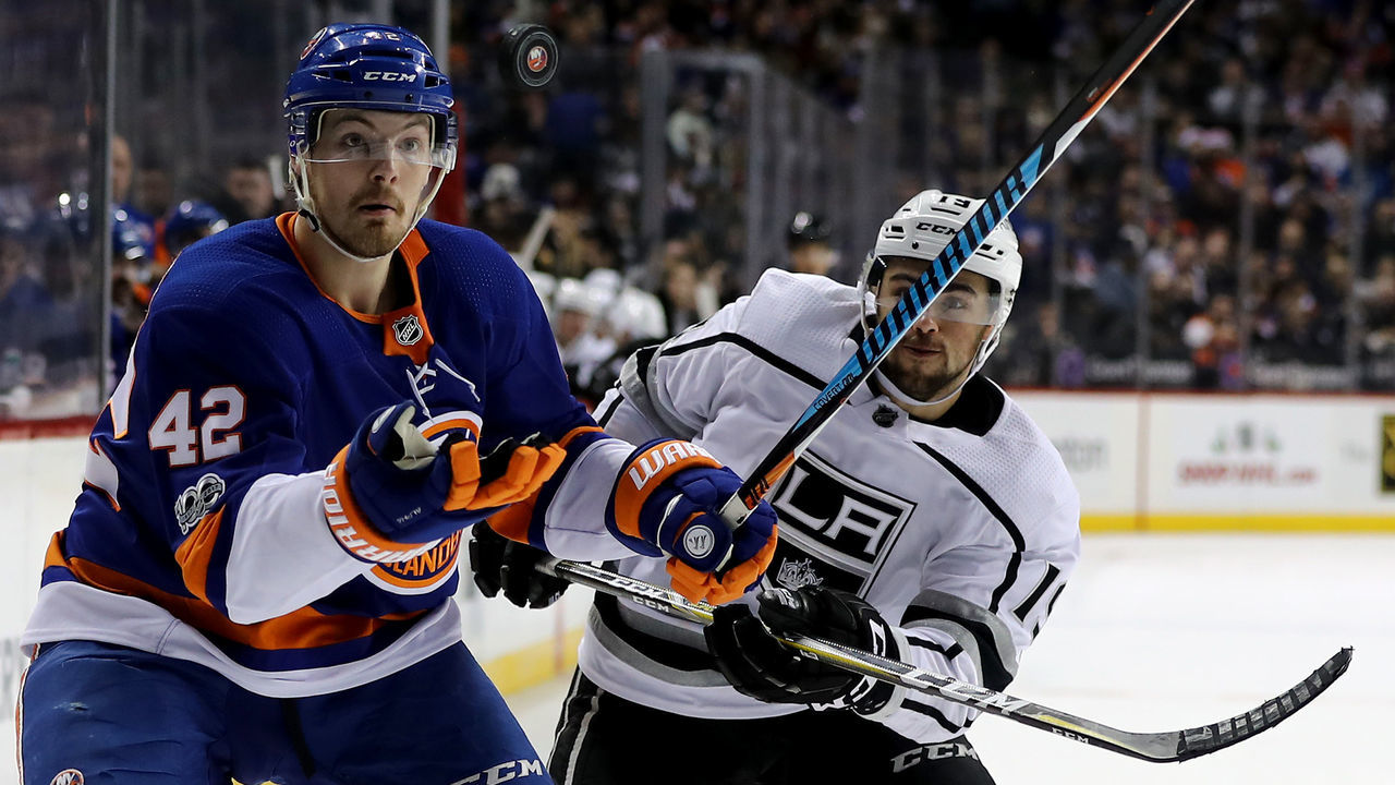 NEW YORK, NEW YORK - DECEMBER 16: Scott Mayfield #42 of the New York Islanders and Alex Iafallo #19 of the Los Angeles Kings fight for the puck in the second period on December 16, 2017 at Barclays Center in the Brooklyn borough of New York City.