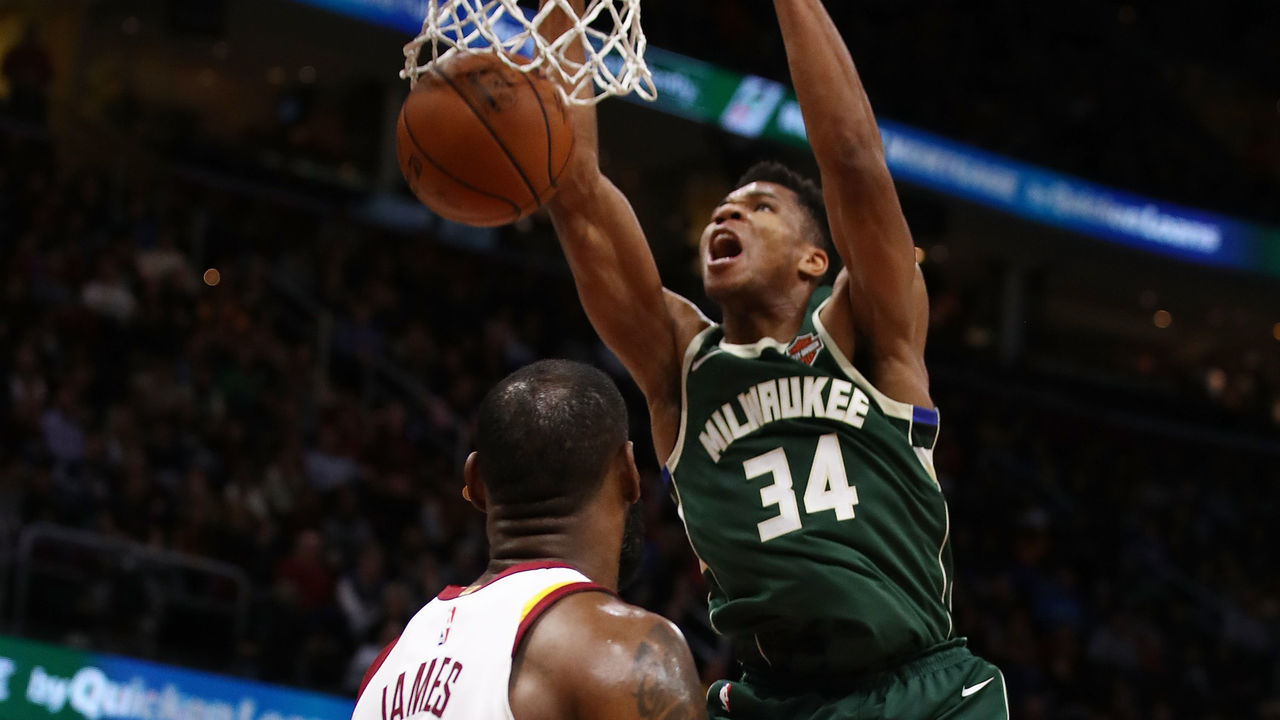 CLEVELAND, OH - NOVEMBER 07: Giannis Antetokounmpo #34 of the Milwaukee Bucks dunks behind LeBron James #23 of the Cleveland Cavaliers during the first half at Quicken Loans Arena on November 7, 2017 in Cleveland, Ohio.