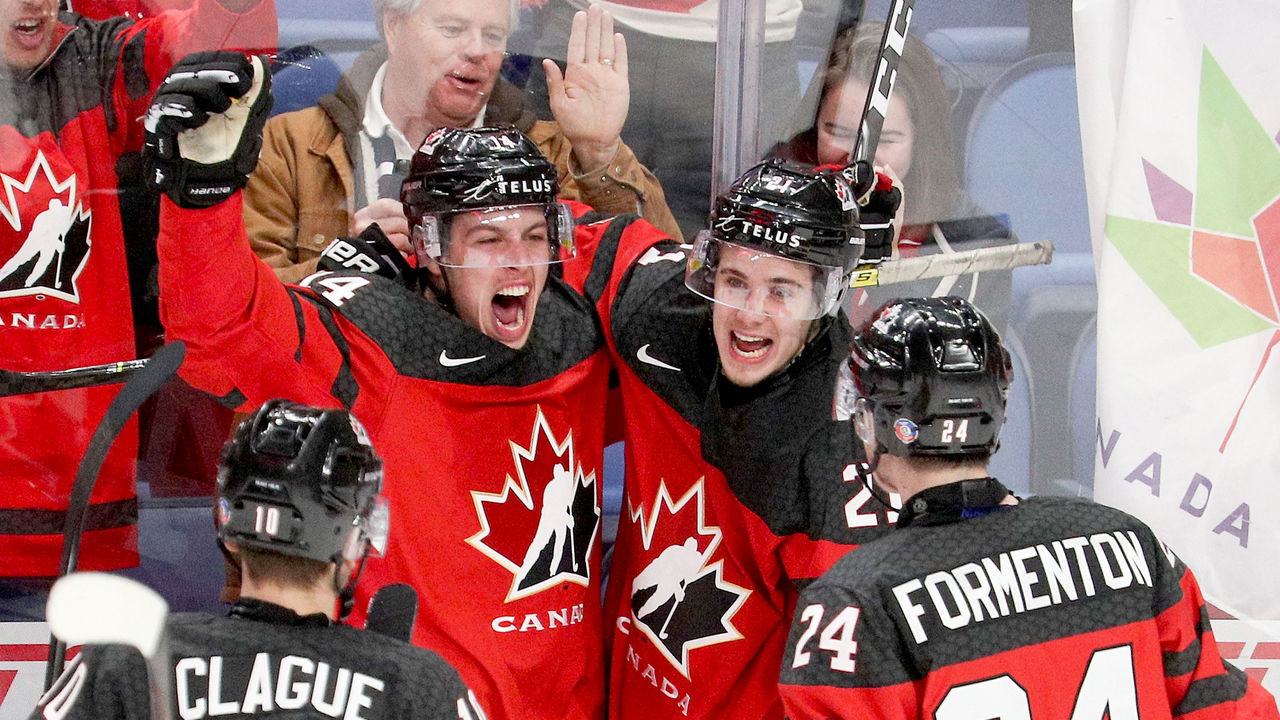 BUFFALO, NY - JANUARY 04: Maxime Comtois #14 of Canada celebrates with Kale Clague #10, Alex Formenton #24, and Brett Howden #21 after Comtois' goal gave team Cananda a 4-1 lead during the second period of play in the IIHF World Junior Championships Semifinal game at KeyBank Center on January 4, 2018 in Buffalo, New York.