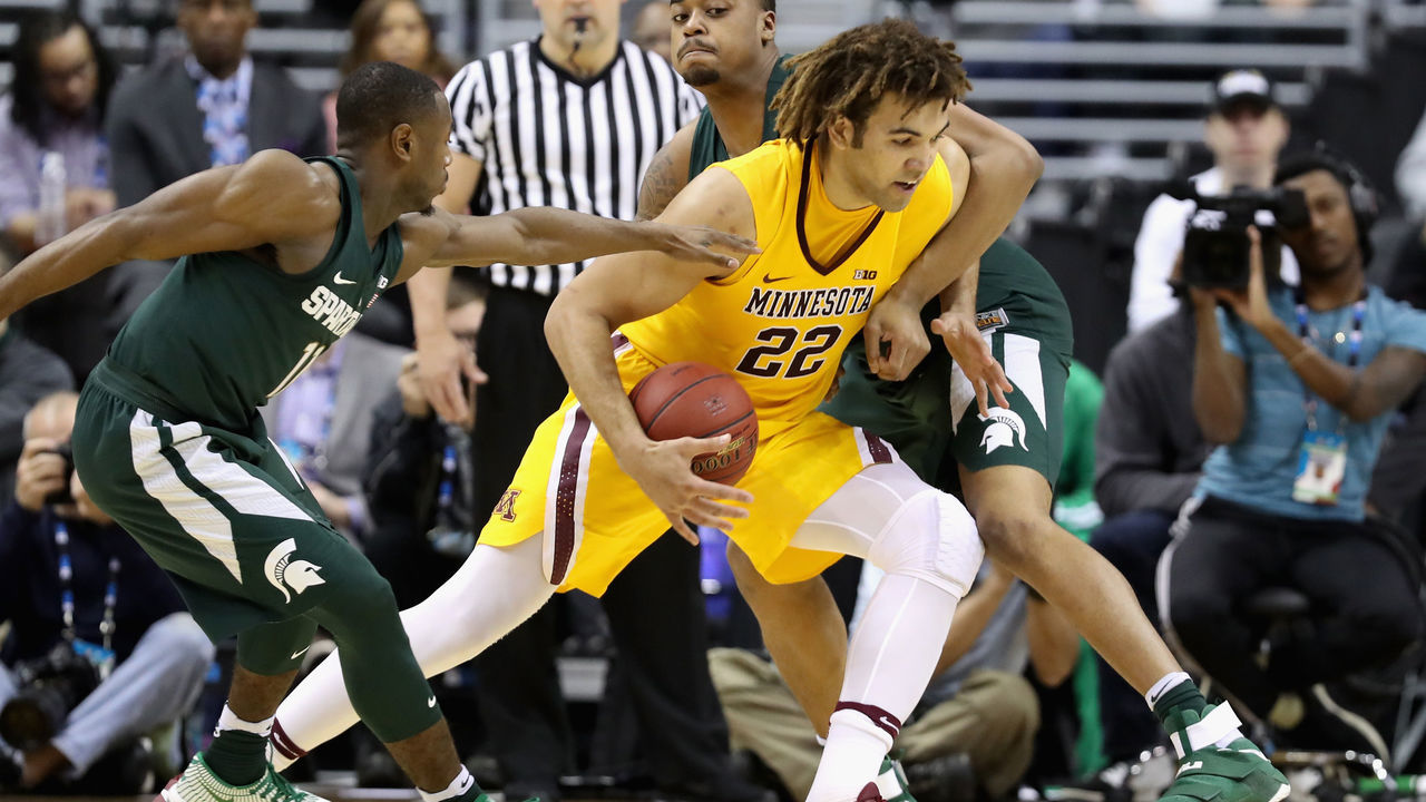 WASHINGTON, DC - MARCH 10: Reggie Lynch #22 of the Minnesota Golden Gophers drives against Lourawls Nairn Jr. #11 and Nick Ward #44 of the Michigan State Spartans during the Big Ten Basketball Tournament at Verizon Center on March 10, 2017 in Washington, DC.
