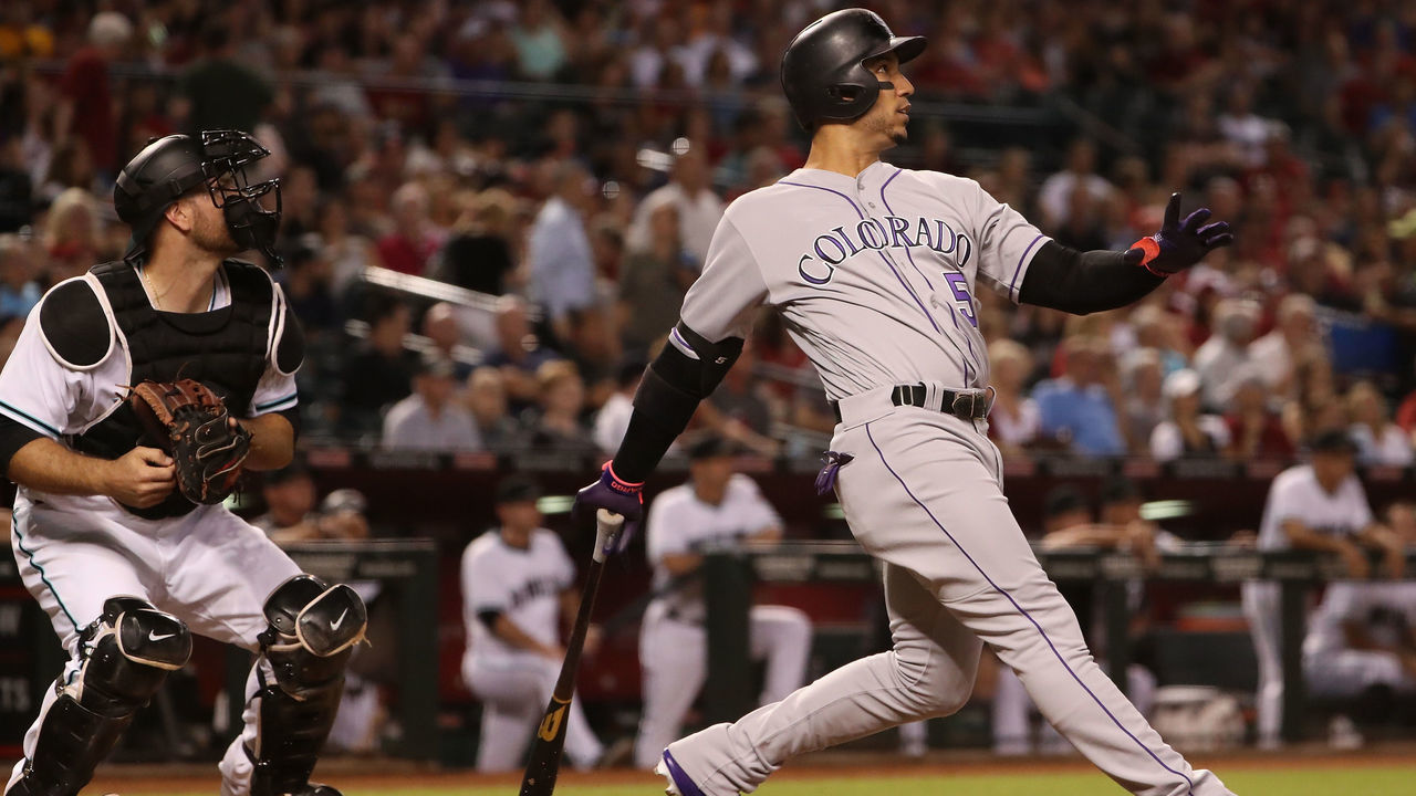 PHOENIX, AZ - SEPTEMBER 12: Carlos Gonzalez #5 of the Colorado Rockies hits a two run home run against the Arizona Diamondbacks during the third inning of the MLB game at Chase Field on September 12, 2017 in Phoenix, Arizona.