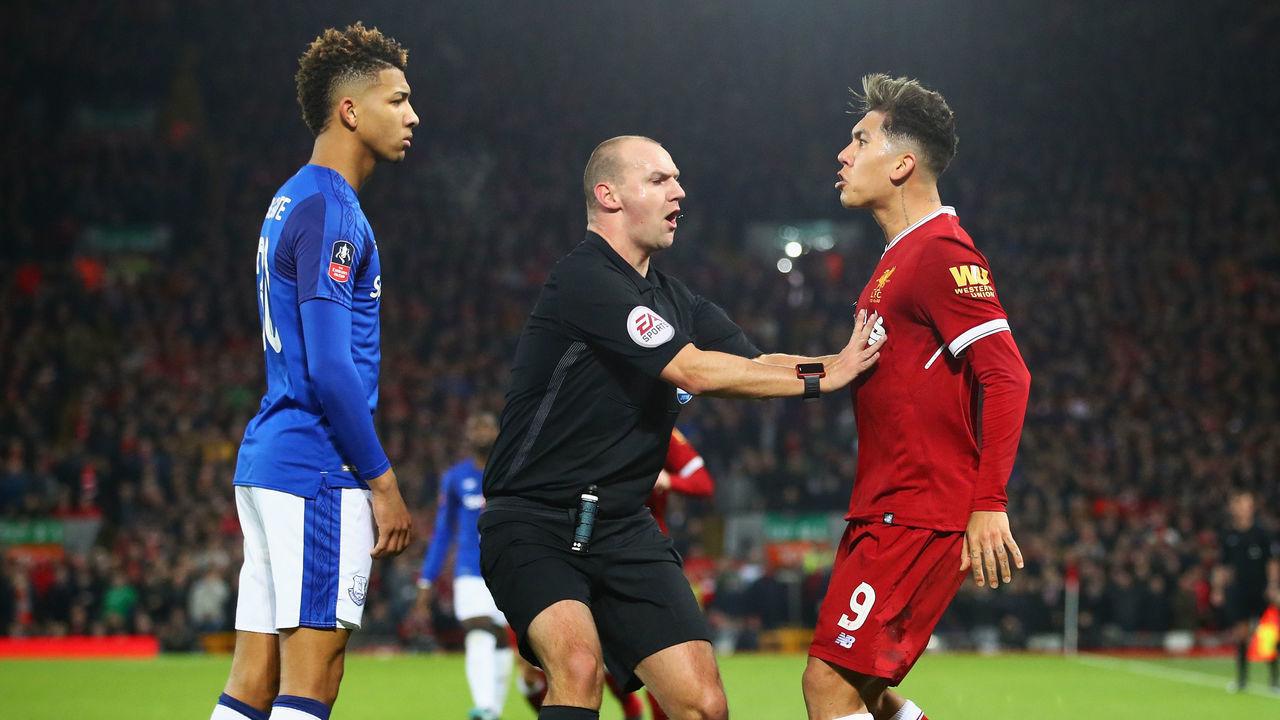LIVERPOOL, ENGLAND - JANUARY 05: Referee Robert Madley intervenes as Mason Holgate of Everton and Roberto Firmino of Liverpool clash during the Emirates FA Cup Third Round match between Liverpool and Everton at Anfield on January 5, 2018 in Liverpool, England.