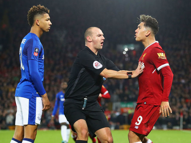LIVERPOOL, ENGLAND - JANUARY 05: Referee Robert Madley intervenes as Mason Holgate of Everton and Roberto Firmino of Liverpool clash during the Emirates FA Cup Third Round match between Liverpool and Everton at Anfield on January 5, 2018 in Liverpool, England.