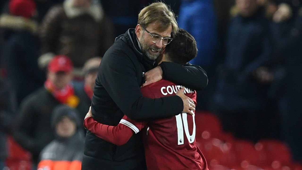 Liverpool's German manager Jurgen Klopp (L) hugs Liverpool's Brazilian midfielder Philippe Coutinho (R) applauds after the final whistle during the English Premier League football match between Liverpool and Swansea City at Anfield in Liverpool, north west England on December 26, 2017. / AFP PHOTO / Paul ELLIS /