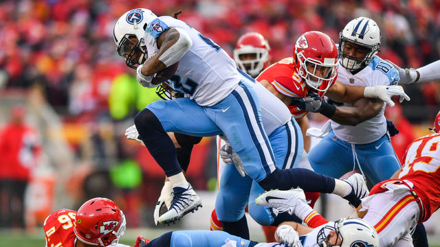 KANSAS CITY, MO - JANUARY 6: Running back Derrick Henry #22 of the Tennessee Titans leaps over a pile of players during the second quarter of the AFC Wild Card playoff game against the Kansas City Chiefs at Arrowhead Stadium on January 6, 2018 in Kansas City, Missouri.