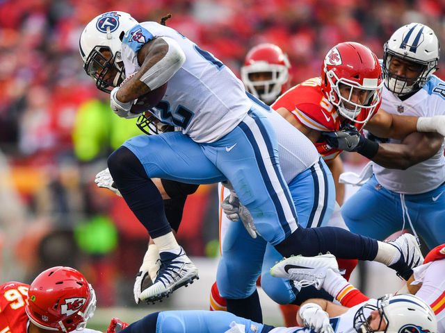 KANSAS CITY, MO - JANUARY 6: Running back Derrick Henry #22 of the Tennessee Titans leaps over a pile of players during the second quarter of the AFC Wild Card playoff game against the Kansas City Chiefs at Arrowhead Stadium on January 6, 2018 in Kansas City, Missouri.