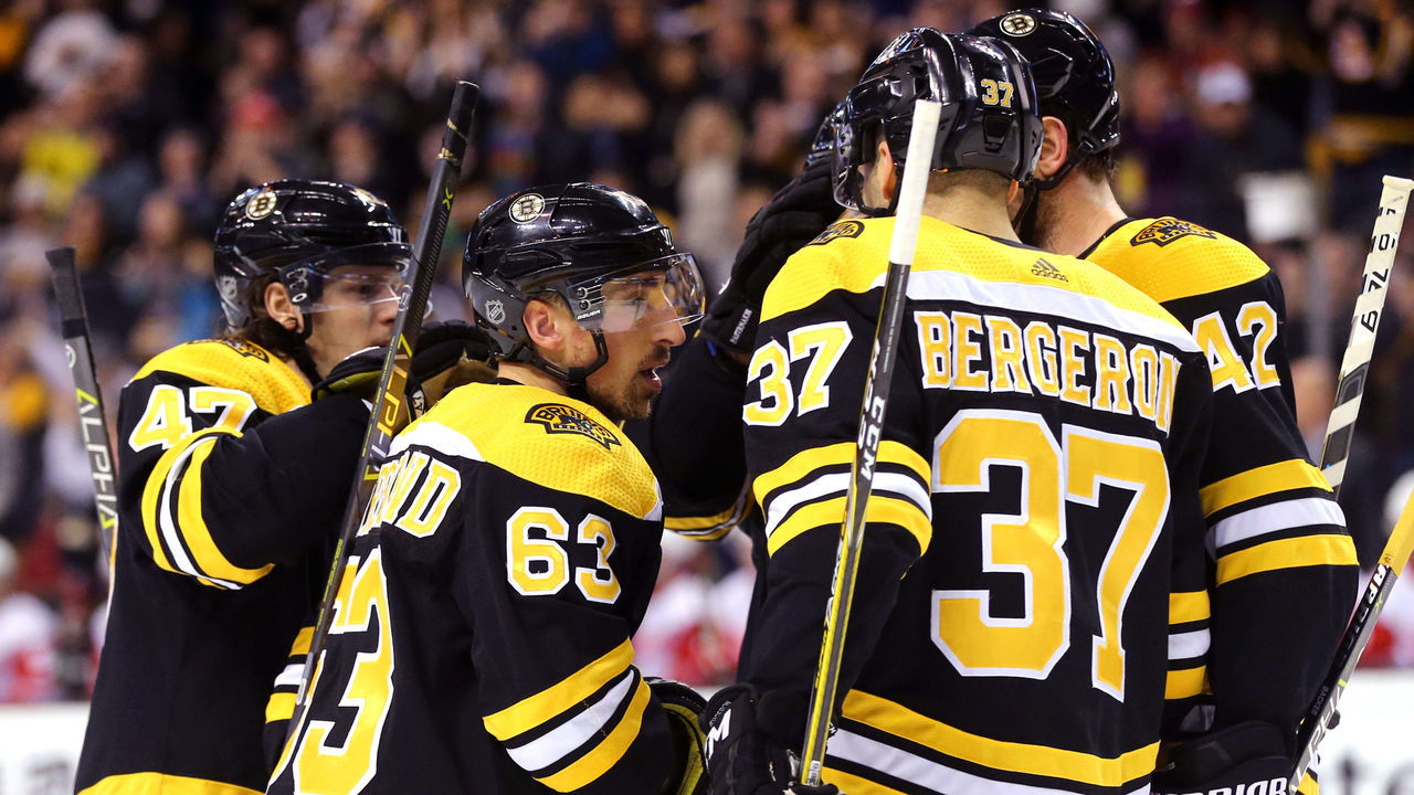BOSTON, MA - DECEMBER 23: Brad Marchand #63 of the Boston Bruins celebrates with Patrice Bergeron #37 and Torey Krug #47 after scoring against the Detroit Red Wings during the first period at TD Garden on December 23, 2017 in Boston, Massachusetts.