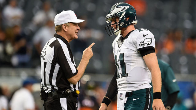 CHICAGO, IL - SEPTEMBER 19: Referee Jeff Triplette #42 talks with quarterback Carson Wentz #11 of the Philadelphia Eagles prior to the game against the Chicago Bears at Soldier Field on September 19, 2016 in Chicago, Illinois.