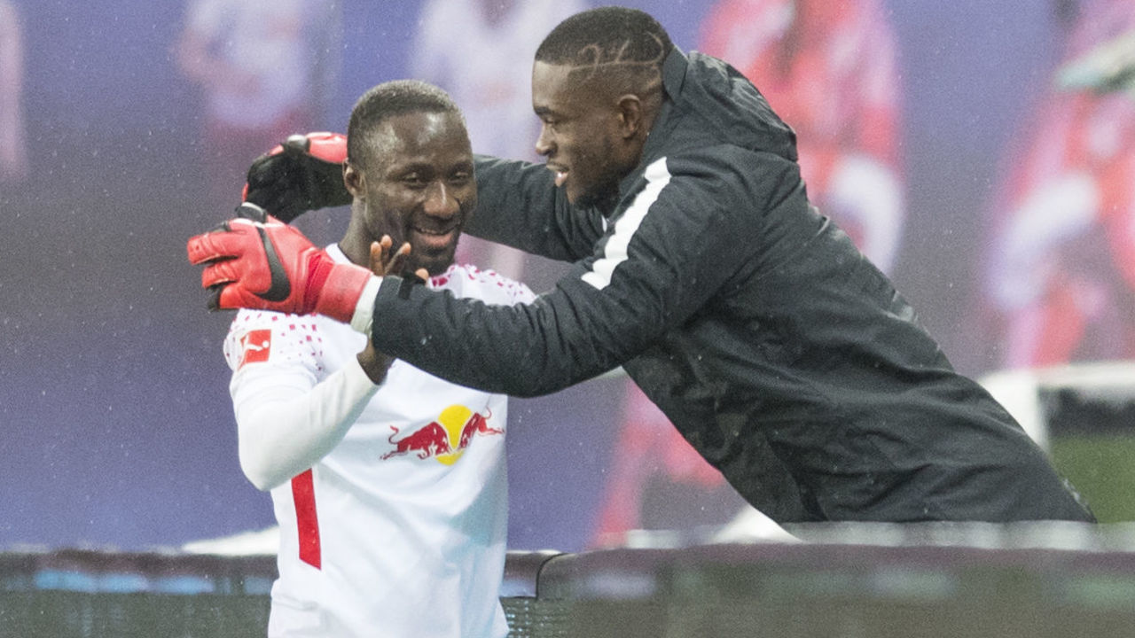 Leipzig's Guinean midfielder Naby Keita (L) celebrates scoring with Leipzig's Swiss goalkeeper Yvon Mvogo during the German first division Bundesliga football match between RB Leipzig and Werder Bremen in Leipzig, eastern Germany on November 25, 2017. during the German First division Bundesliga football match between RB Leipzig and Werder Bremen in Leipzig, eastern Germany, on November 25, 2017. / AFP PHOTO / ROBERT MICHAEL / RESTRICTIONS: DURING MATCH TIME: DFL RULES TO LIMIT THE ONLINE USAGE TO 15 PICTURES PER MATCH AND FORBID IMAGE SEQUENCES TO SIMULATE VIDEO. == RESTRICTED TO EDITORIAL USE == FOR FURTHER QUERIES PLEASE CONTACT DFL DIRECTLY AT + 49 69 650050