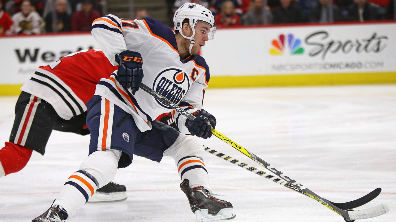 CHICAGO, IL - JANUARY 07: Connor McDavid #97 of the Edmonton Oilers advances the puck under pressure from Duncan Keith #2 of the Chicago Blackhawks at the United Center on January 7, 2018 in Chicago, Illinois.